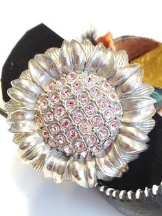 "Beautiful vintage brooch pin, silver tone metal petals with sparkling pink rhinestones in th middle of sunflower. Pics seems to not be able to capture, the pretty sparkle of this brooch. Measures 2\" diameter MOD signature on the back In excellent vintage condition 'MOD' signed" Sunflower Pics, Ocean Springs Ms, Sun Designs, Pretty Necklaces, Cowrie Shell, Shell Earrings, Vintage Brooch, Pink Rhinestones, Gorgeous Gift