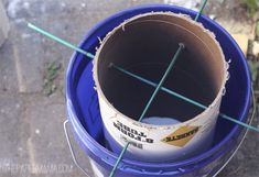 a blue bucket with some stick sticking out of it