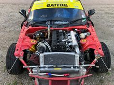 the front end of a race car with its engine exposed