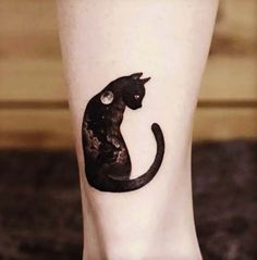 a black cat tattoo on the leg of a woman's foot, with her eyes closed