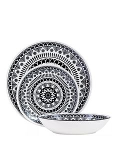 three black and white plates sitting on top of each other in front of a white background