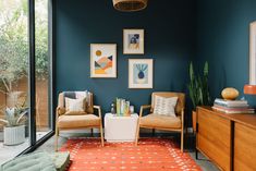 a living room filled with furniture and pictures on the wall