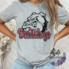 Pick yourself up one of these fun and spirit-filled Bulldogs shirts. This shirt is sure to impress your friends and show your true bulldog spirit. This design is in a cardinal red color.   The shirt is made of 95% polyester and 5% spandex. This shirt is soft with a nice stretch.  To get the best wear from your shirt make sure to  1. Wash in cold water 2. Tumble dry low 3. Do not iron on design area 4. Do not use fabric softener This is faux glitter. The design area is printed to look like glitte Bulldog Cheer Shirts, Bulldogs Shirts School Spirit, Bulldog Football Shirts, Bulldogs Cheer, Bulldogs Sweatshirt, Cheer School, School Spirit Shirts Designs, Cardinal Red Color, Bulldog Tshirt