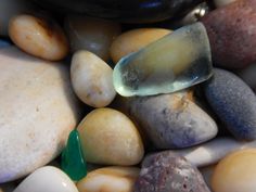 some rocks and stones with a green piece in the middle on it's side