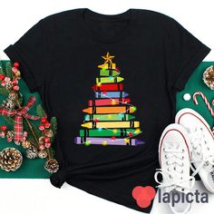 ✔️ TITTLE : Crayons Tree Colored Lights Teacher T-Shirt, Crayon Shirt, Teacher Shirt, Kindergarten Shirt, Teacher's Day Gift ✔️ IMPORTANT: Both Men and Women can we our shirts because this is unisex style t-shirts; Wash item inside out in cold water, do not bleach, do not dry clean, do not iron directly on the design. ✔️ MATERIAL DETAILS: 5.3-ounce, 100% cotton (99/1 cotton/poly (Ash) & 90/10 cotton/poly (Sport Grey); Heavyweight classic unisex tee; Taped neck and shoulders; Tearaway label ;Deco Christmas Tshirts Teacher, Christmas Graphic Print Multicolor Tops, Christmas Multicolor Graphic Print Top, Multicolor Graphic Print Christmas Top, Multicolor Cotton Christmas Top, Holiday Multicolor Graphic Print Tops, Multicolor Graphic Print Holiday Tops, Summer Sportswear, Colored Lights