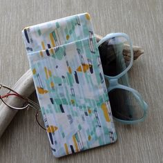 "This double eyeglass case is a great organizer for 2 pairs of glasses. Made up in aqua, white and ivory abstract modern print cotton fabric with an ivory cotton fabric lining. There are 2 pockets. The main pocket will accommodate your sun glasses or eye glasses and the outside pocket is an easy slip in for your readers or a second pair of glasses. Both pockets are fully lined and there is interfacing for good structure to the sleeve. An alternate way to use this case would be for some size cell Modern Green Rectangular Cases, Small Glasses, Glasses Cases, Leopard Print Fabric, Eye Wear, Eyeglass Holder, Modern Print, Eyeglass Case, Glasses Case