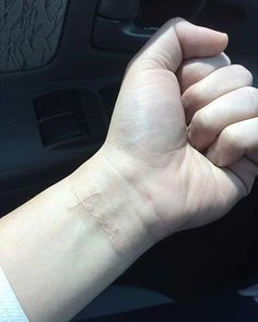 a person's arm with a small tattoo on the left side of their wrist