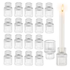 twelve clear glass candlesticks with one lit candle in the middle and several empty ones