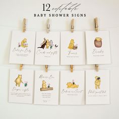 baby shower signs with winnie the pooh characters hanging from clothes pegs on a white wall