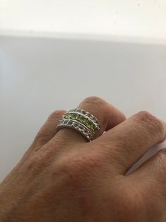 Rich bright Peridot green and white sapphire ring Sterling silver Tarnished with age, can be polished up. Size 8 can be sized by my jeweler. His service charge is $10-$20 All rings are shipped free in the US in a nice gift box. Check out our over a THOUSAND great reviews Engraving is $4 per letter and is not always perfect depending on the piece. It can take a few days if the jeweler is busy. This is payable to Paypal Judithsltd@gmail.com Green Diamond Multi-stone Birthstone Ring, Green Diamond Birthstone Ring With Multi-stone, Fine Jewelry Green Channel Set Ring, Green Multi-stone Rings For May Birthstone, Green Round Diamond Ring With Channel Set, Green Channel Set Jewelry For Anniversary, Anniversary Green Channel Set Jewelry, Fine Jewelry With Channel Set Green Stones, Fine Jewelry Green Channel Set