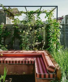 an outdoor hot tub in the middle of a garden