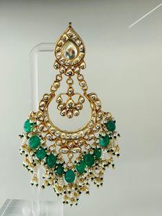 Green Morni long earring will surely make you look like a royalty.A refined handmade jewellery engraved with real kundan stones. Each piece has an intricate bead work to enrich its elegance. Traditional 22k Gold Bridal Earrings For Festive Occasions, Elegant Kundan Drop Earrings, Elegant Kundan Drop Danglers, Festive Gold Plated Chandelier Earrings, Festive Gold Plated Danglers Gift, Kundan Temple Jewelry Earrings, Festive Gold Beaded Drop Earrings, Festive Temple Jewelry Danglers With Intricate Design, Elegant Chandbali Beaded Earrings As Gift