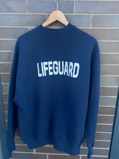 "Vintage 1990s Lifeguard Navy Blue Crewneck Sweatshirt  - Size XL (Length 28\" Chest 23\") - Overall great vintage condition (no holes/no stains) - Message for more information Please take note of the measurements listed as these are vintage clothes and may fit different than the tag size. Follow our page for more vintage clothing drops! Connect with us on Instagram: @recurarchives" 90s Oversized Sweatshirt For Sports, 90s Style Relaxed Fit Sports Sweatshirt, 90s Style Relaxed Fit Sweatshirt For Sports, Lifeguard Outfit, Lifeguard Hoodie, Navy Blue Crewneck, 90s Crewneck, Crewneck Vintage, Blue Crewneck