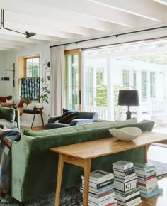 a living room filled with furniture and a wooden table in front of a sliding glass door