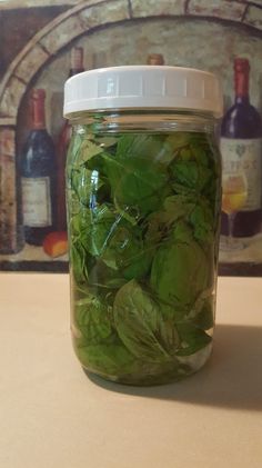 a jar filled with lots of green leafy vegetables