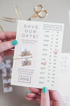 a person holding up a ticket for their date to save the date with scissors and paper clips