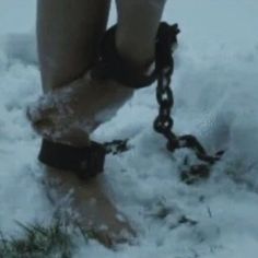 a person with chains on their feet in the snow