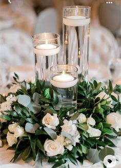 the centerpieces are filled with candles and flowers