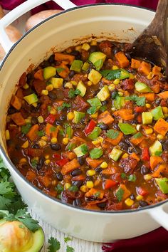 a pot filled with stew and vegetables on top of a table