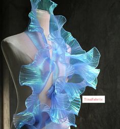 a mannequin with blue ruffles on it's back and neck