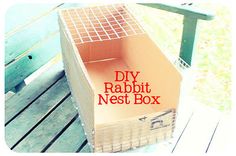 a cardboard box sitting on top of a wooden bench with the words diy rabbit nest box