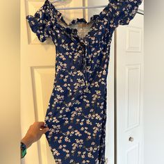 Blue Stretchy, Slim Fit Off Shoulder Beach Dress With White Flowers, Never Worn, New Without Tags. Tie Front At Bust For Adjusting Size Slightly. Blue Fitted Beach Dress, Fitted Blue Beach Dress, Fitted Dress For Summer Beach Outings, Blue Dresses For Summer Outings, Blue Short Sleeve Sundress For Beach Season, Blue V-neck Mini Dress For Beach Party, Blue Floral Print Beachy Sundress, Blue Knee-length Sundress For Beach Season, Blue Short Sleeve Beach Dress For Day Out