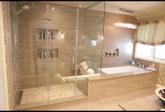 a bath room with a sink and a bath tub next to a shower head mounted on the wall