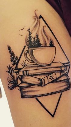 a tattoo with books and a cup of coffee on top of each other in the shape of a triangle