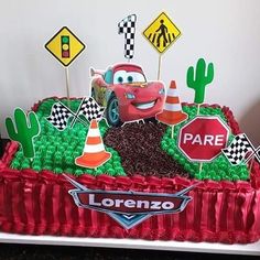 a birthday cake with cars and traffic signs on it