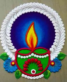 a colorful diwali with a lit candle on it's face and leaves around the edges