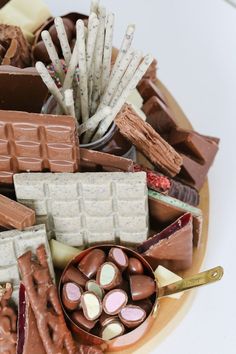 a bowl filled with lots of different types of chocolates and marshmallows