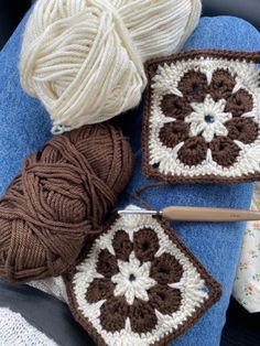 two crocheted grannys are sitting next to each other on a blue blanket