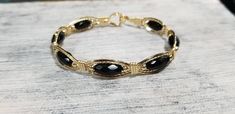 Beautiful Black Onyx faceted gemstones wrapped in Luscious 14kt Gold Filled wire. Elegant Onyx Bracelet With Faceted Beads, Elegant Onyx Bracelets With Faceted Beads, Elegant Onyx Wire Wrapped Jewelry, Adjustable Oval Jewelry With Faceted Beads, Elegant Wire Wrapped Round Beaded Bracelets, Elegant Hand-wrapped Black Beaded Bracelets, Onyx Gemstone Bracelet, Elegant Wire Wrapped Bracelet Jewelry, Elegant Wire Wrapped Bracelet