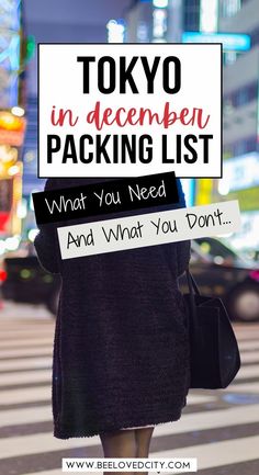 a woman walking across a street holding a sign that says tokyo in december packing list what you need and what you don't