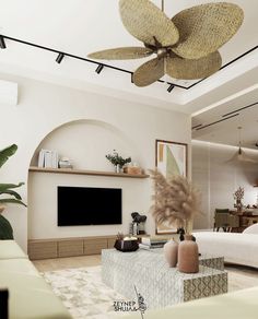 a living room filled with furniture and a flat screen tv mounted on the wall next to a fireplace