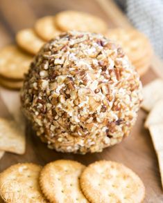 a cheese ball and crackers on a cutting board with the words classic cheeseball