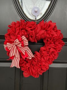 a red wreath on the front door of a house