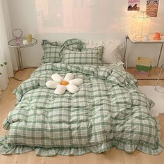 a bed with green and white checkered comforter on it