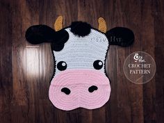 a crocheted cow head is shown on a wooden floor with the words, get crafty crochet pattern