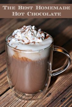 the best homemade hot chocolate in a glass mug on a wooden table with text overlay that reads, the best homemade hot chocolate