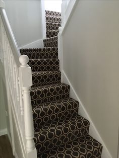 a set of stairs with black and white carpet