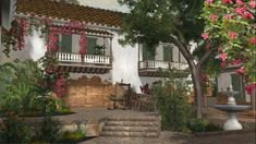 a white house with pink flowers on the balcony and steps leading up to it's second story