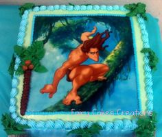 a cake decorated with a naked woman on a tree branch and blue icing frosting