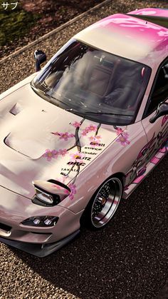 a pink car with flowers painted on it