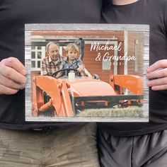 a man and woman holding up an old fashioned car with the words michael & grandpa on it