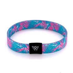 "Take a cruise down Ocean Drive in Miami Beach! Art deco meets tropical pink and mint palm leaves with this breezy band. Get ready to make waves with these beachy bracelets! Super comfy on your wrist and they keep their vibrant colors all summer long. Stack them up, mix and match with our knotband bracelets. Available in bracelet lengths (L): Extra Small approx 5.5\" L Small approx 6.5\" L Medium approx 7.5\" L Large / Anklet approx 9\" L Reversible surf, music and beachy prints. Elastic blend m Adjustable Pink Summer Bracelets, Adjustable Tropical Bracelets For Vacation, Adjustable Tropical Style Bracelets For Vacation, Adjustable Multicolor Wristband For Summer, Casual Pink Bracelets For Summer, Summer Casual Pink Jewelry, Casual Pink Summer Bracelets, Adjustable Summer Beach Wristband, Adjustable Turquoise Bracelet For Summer