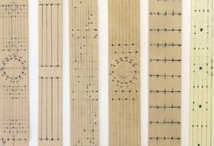 five different types of rulers lined up on a white surface with lines drawn across them