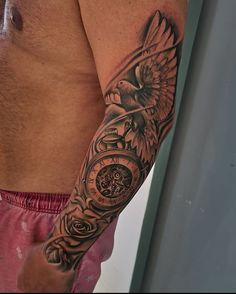 a man with a clock and bird tattoo on his arm