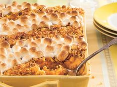 a casserole dish filled with thanksgiving stuffing and topped with marshmallows