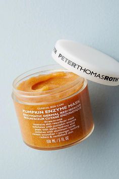 a jar of pumpkin spice face mask sitting on a white surface